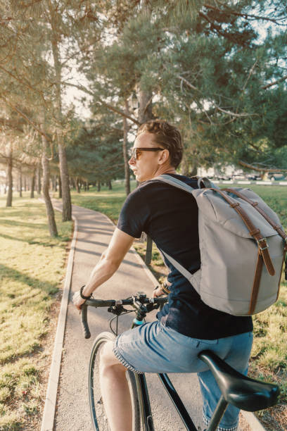 istock Young man riding on a bicycle in the park. 1321187435