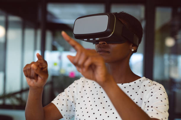 istock Smiling african american woman using vr headset at work 1321187565