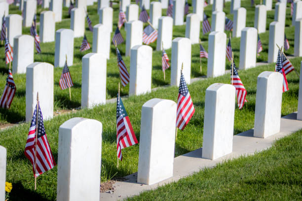 Military Headstones and Gravestones Decorated With Flags for Memorial Day Military headstones honoring armed forces servicemen decorated with American flags for Memorial Day national cemetery stock pictures, royalty-free photos & images