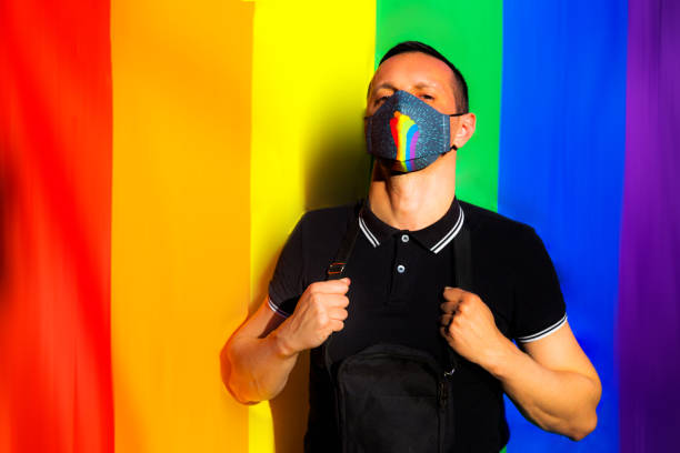 istock Man posing with large rainbow flag. LGBTQ concept 1321195346