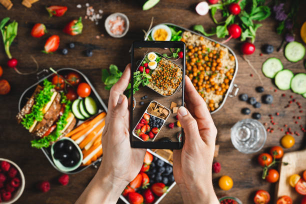 istock Woman photographing healthy lunch boxes 1321195569