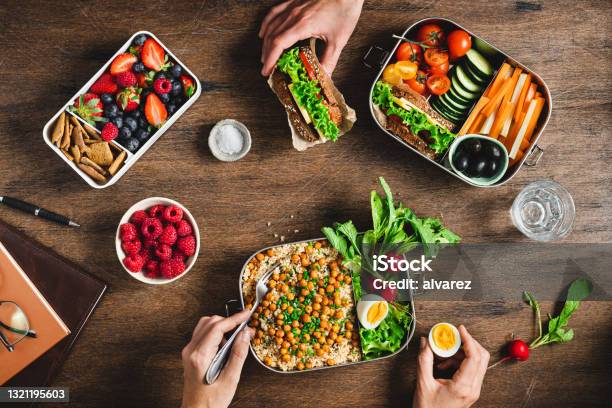 People Having Balanced Diet From Lunch Boxes Stock Photo - Download Image Now - Healthy Eating, Lunch, Food