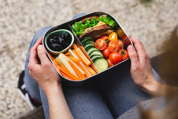 istock Woman with healthy lunch box 1321195684
