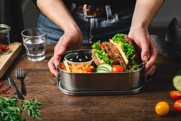 closeup of a woman making a healthy lunch box - chive blossom imagens e fotografias de stock