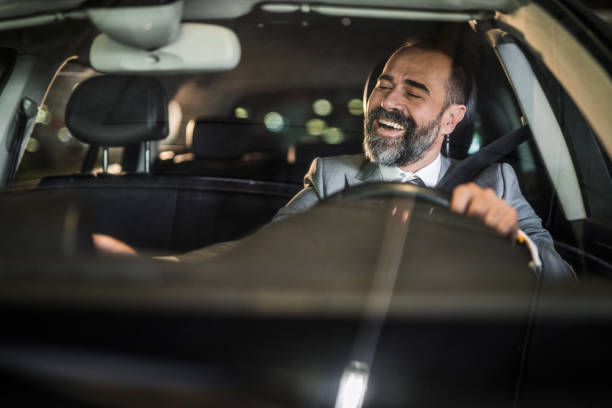 Businessman driving a car. Happy businessman driving his car and singing to music. vehicle interior audio stock pictures, royalty-free photos & images