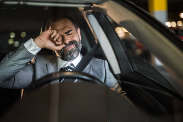 Young business man sitting on rear seats and stretching.