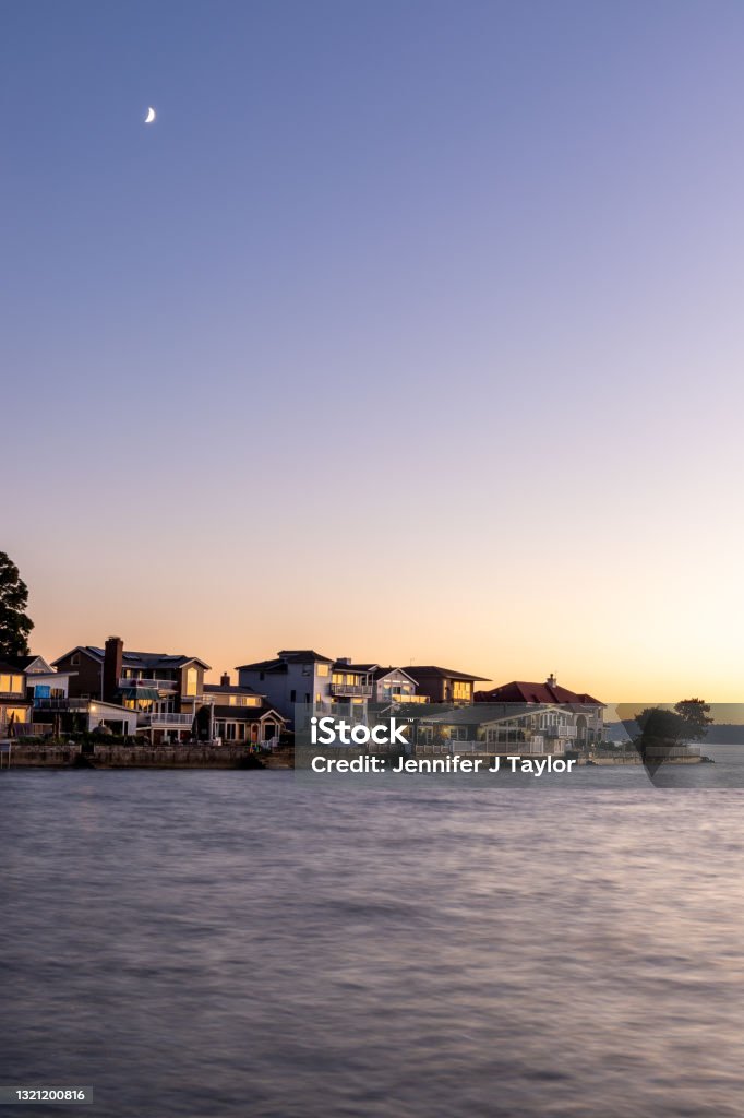 Sunset Over Coastline with Houses, and Moon in Sky Sunset in Tacoma, WA, USA in 2020 Tacoma Stock Photo