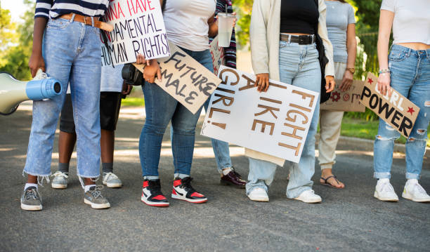 Group of young women standing with signs during a women's day march Diverse group of unrecognizable young women standing with signs on a street during a women's day march womens issues stock pictures, royalty-free photos & images