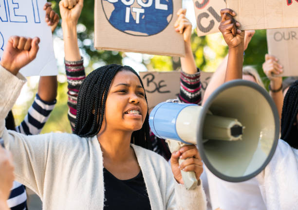 istock Diverse group of people chanting slogans during a climate change march 1321201021