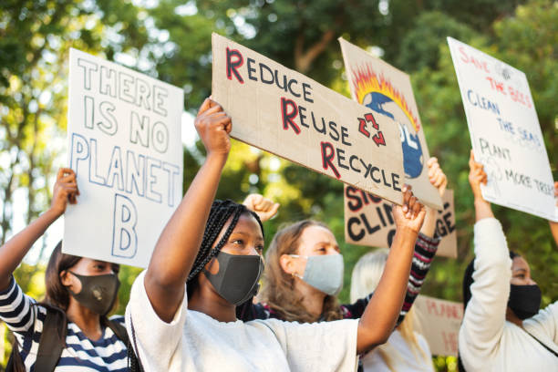 istock Diverse teenage friends wearing face masks protesting climate change 1321201047
