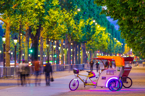 Tourist pedicab on a boulevard along the Avenue des Champs-Élysées in Paris France