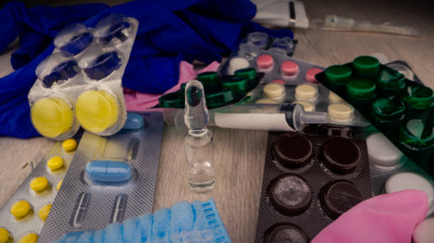 istock Coloured pills and sterile medical tools surround vial 1321204093