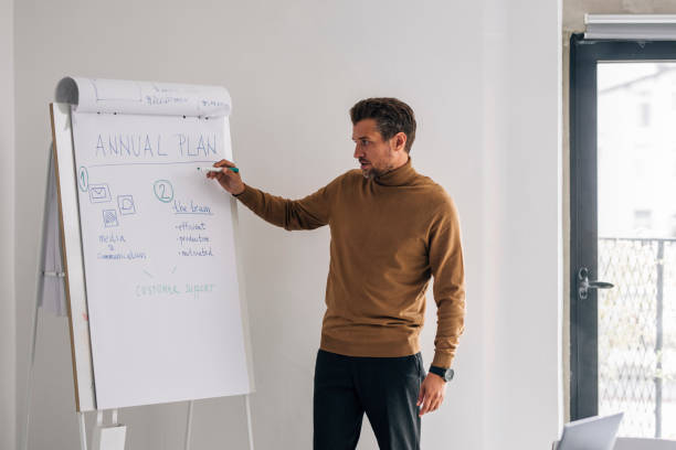 istock Handsome Young Businessman Giving a Presentation on his Project at Work 1321204846