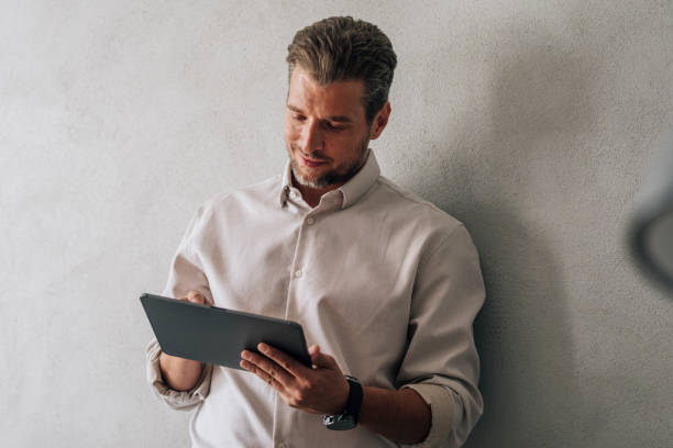 istock Portrait of a Handsome Young Businessman Using a Digital Tablet at Work 1321204919