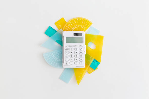School rulers and calculator on grey background. Top view with copy space. Flat lay. Back to school concept.