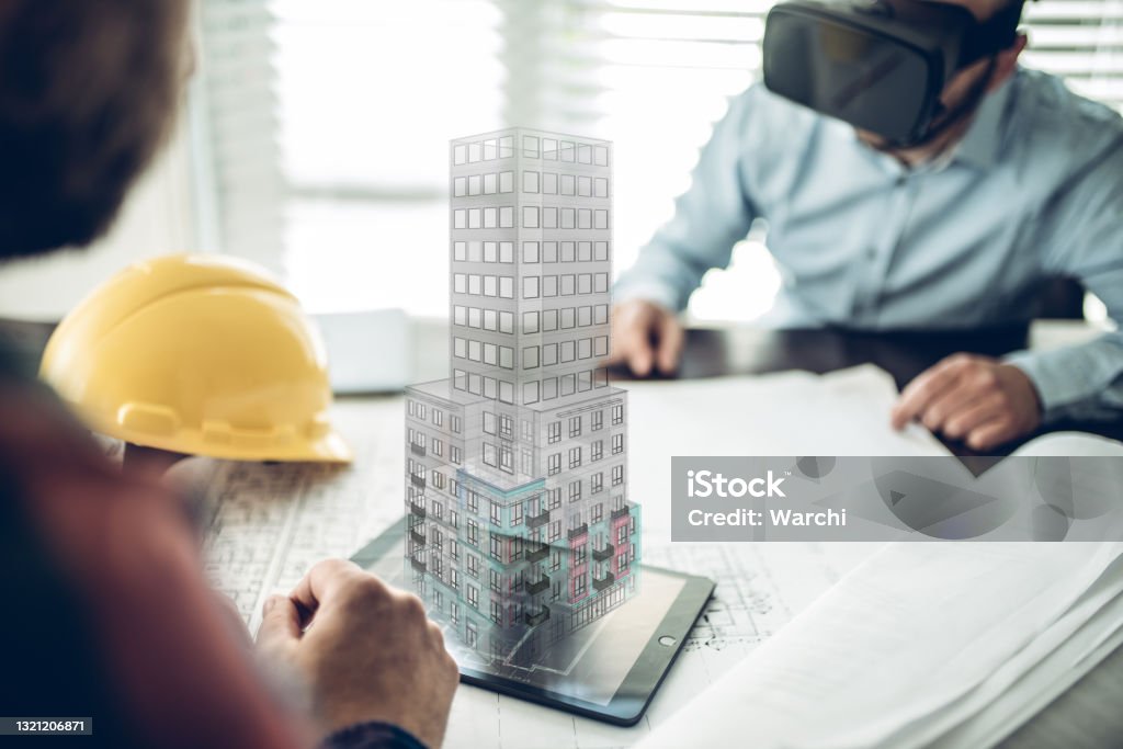 Architects using virtual reality Male Architect wearing augmented reality headsets looking at the virtual model of his project. He has a coordination meeting to present the project Building Information Modeling Stock Photo