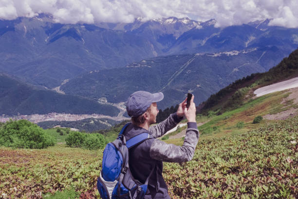 istock A man uses a smartphone while traveling in the mountains 1321206897