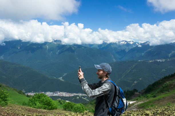 istock A man uses a smartphone while traveling in the mountains 1321206905