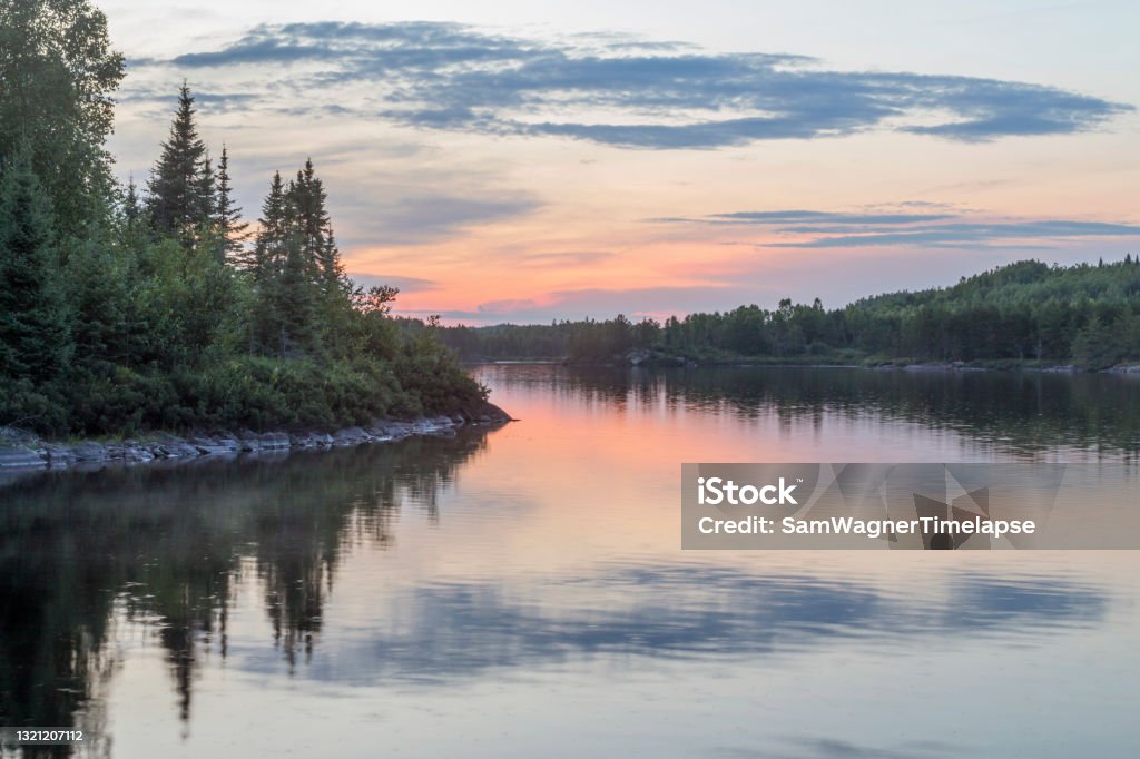 A Beautiful Summer Sunset Reflecting in Vern Lake in the BWCA of Northern Minnesota A Shot of Beautiful Sunset Reflections in a Calm Vern Lake in the Boundary Waters Canoe Area Wilderness of Northern Minnesota Water Stock Photo