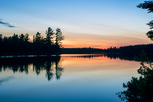 A Wide Angle Shot of Twilight Sky over the Boundary Waters Reflecting in a Calm Disappointment Lake in Northern Minnesota