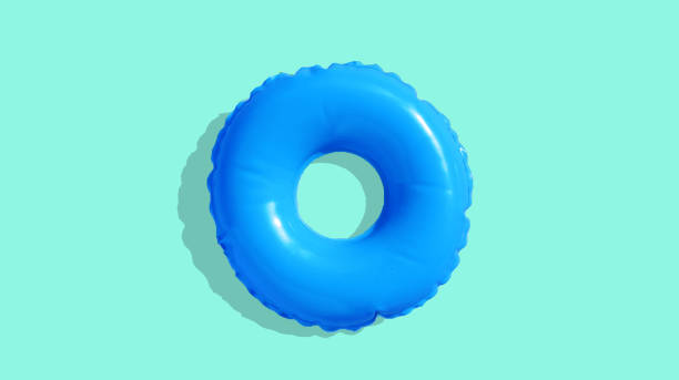 istock Blue inflatable swimming pool ring on blue background. 1321208799