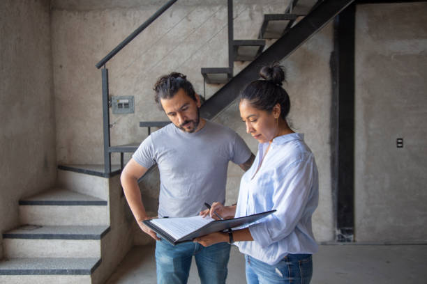 istock Woman real estate agent, showing documents to client 1321209940