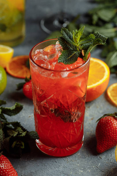 istock Colorful refreshing drinks for summer, cold strawberry lemonade juice with ice cubes in the glasses garnished with sliced fresh lemons 1321210511