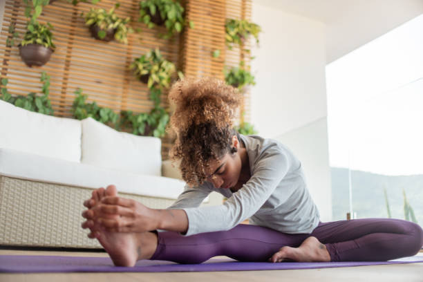 istock Young girl practicing yoga at home. 1321212374