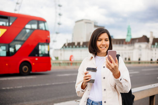 istock Young Woman in London using smartphone 1321212493