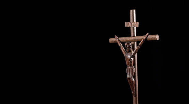 istock Catholic wooden cross, religious symbol - Black background 1321216553