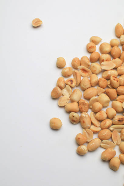 Roasted peanuts isolated on white background, clipping path, full depth of field. Selective focus