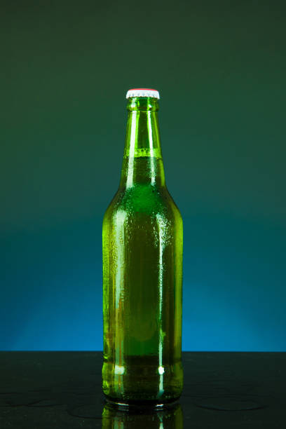istock green beer bottle with drops on blue background 1321218535