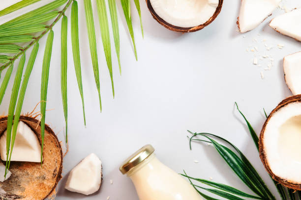 istock Coconut milk bottle, fruit and peel on gray background.Top view, hard light 1321221378