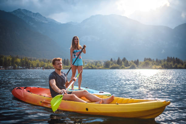 istock Caucasian Couple in Early 30s Paddleboarding and Kayaking 1321221680