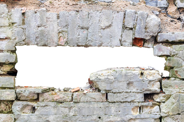 istock destroyed wall of old bricks with a hole in the middle. isolated on white background. grunge frame. horizontal frame 1321223630