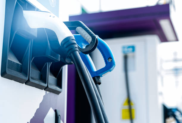 istock Electric car charging station for charge EV battery. Plug for vehicle with electric engine. EV charger. Clean energy. Charging point at car parking lot. Alternative energy. Future transport technology 1321223875