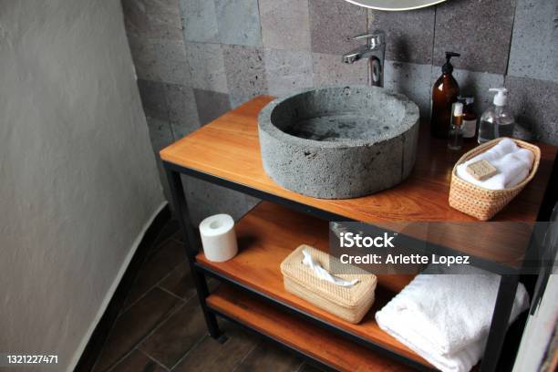 Bathroom In Interior With Gray Stone Wall And Sink With White Towels Stock Photo - Download Image Now