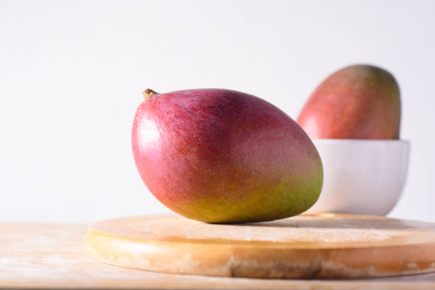 Fresh palmer mango fruit on wooden with white background, Tropical fruit
