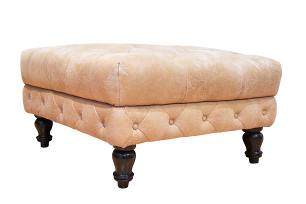 istock Leather padded stool with wooden legs isolated on white background 1321235300