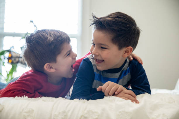 istock Portrait of two young brothers being playful and laughing. 1321237405