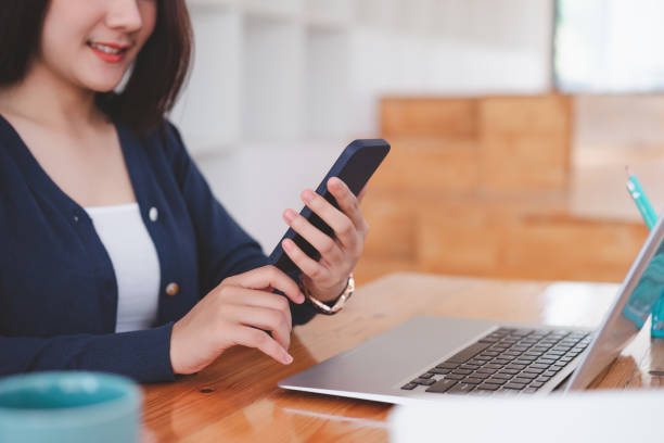 istock Young asian woman worker having a break and using smartphone after working. 1321240842