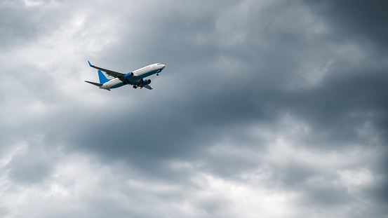 Commercial passenger airplane in the overcast sky