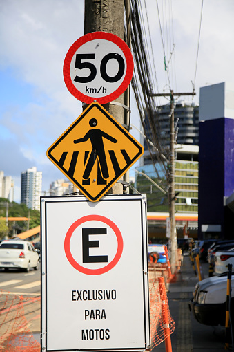 salvador, bahia, brazil - may 26, 2021: traffic signs indicating pedestrian crossing and maximum speed of 50 kilometers per hour and regulated parking in the city of Salvador.