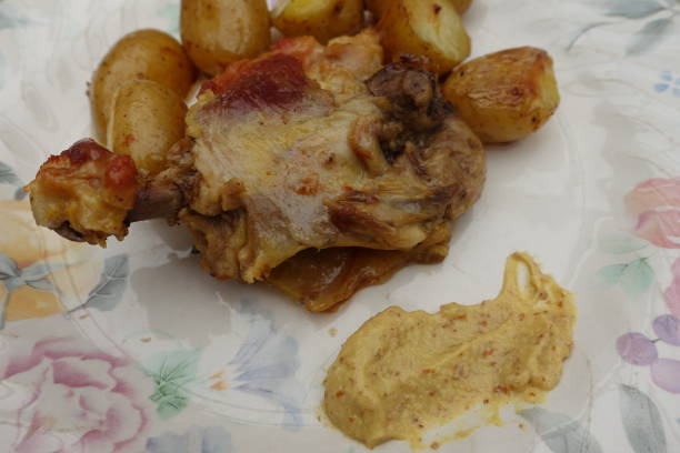 istock Chicken thigh and roasted potatoes served with mustard 1321246685
