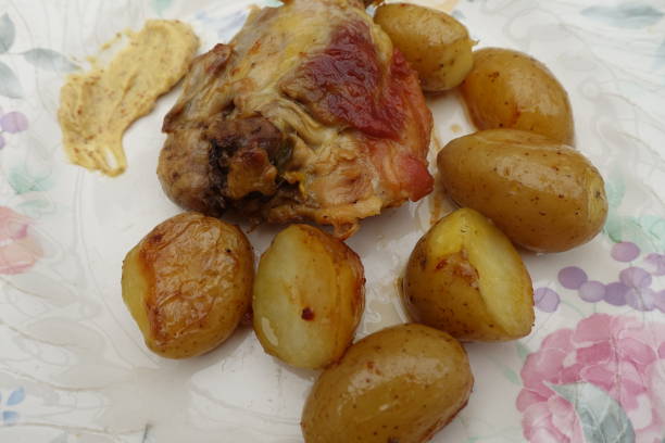 istock Chicken thigh and roasted potatoes served with mustard 1321246693