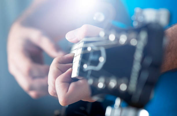 istock Close up on man`s hand playing guitar 1321248787