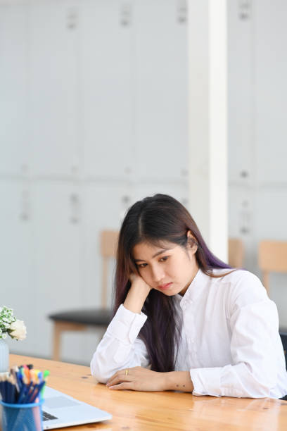 istock Bored young woman office worker sitting at her workplace. 1321248937
