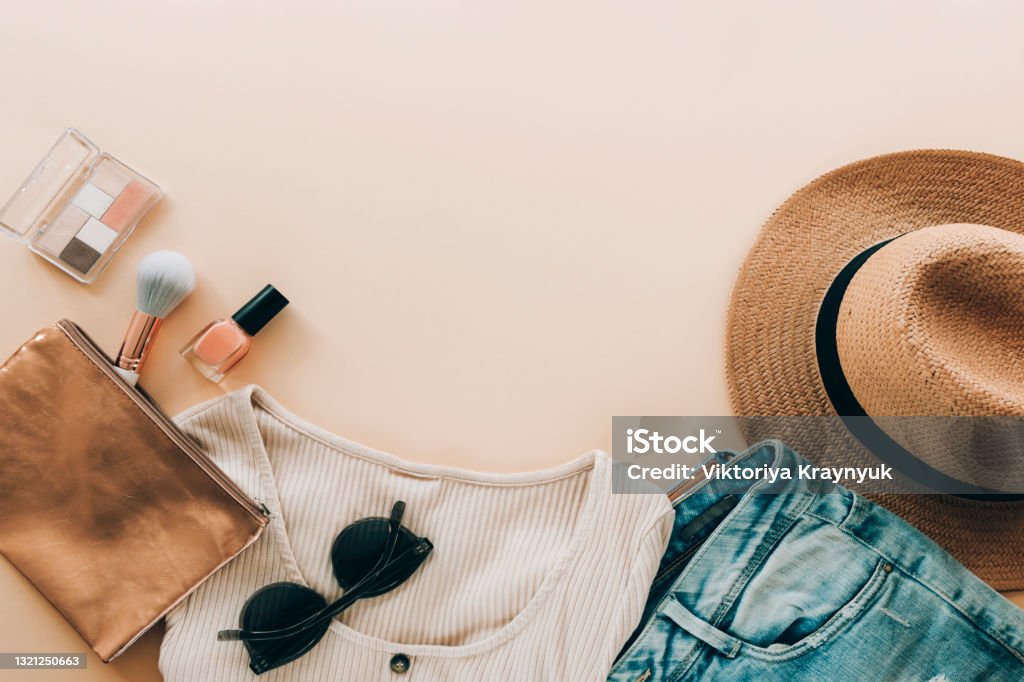 Women's summer clothing and accessories. Beauty, fashion, summer vacation concept. Top view, flat lay, copy space Women's summer clothing and accessories. Beauty, fashion, summer vacation concept. Top view, flat lay, copy space. Flat Lay Stock Photo
