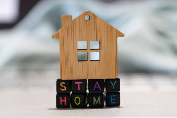istock close up text block and toy house on table, computer. stay and work from home, coronavirus covid-19 crisis risk and problem concept 1321250671