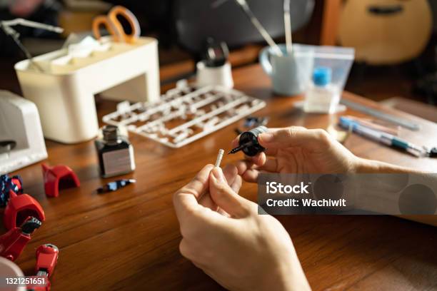 A Man Painting Enamel Paint On A Plastic Model Kit Stock Photo - Download Image Now - Model Kit, Model - Object, Action Figure